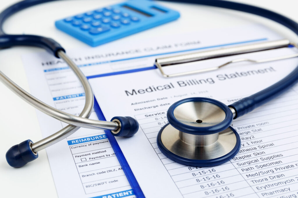 stethoscope on medical bills and health insurance claim form | EnableComp Available Nationwide